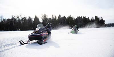People snowmobiling