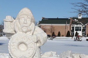 Snow sculpture of a ship captain near a building