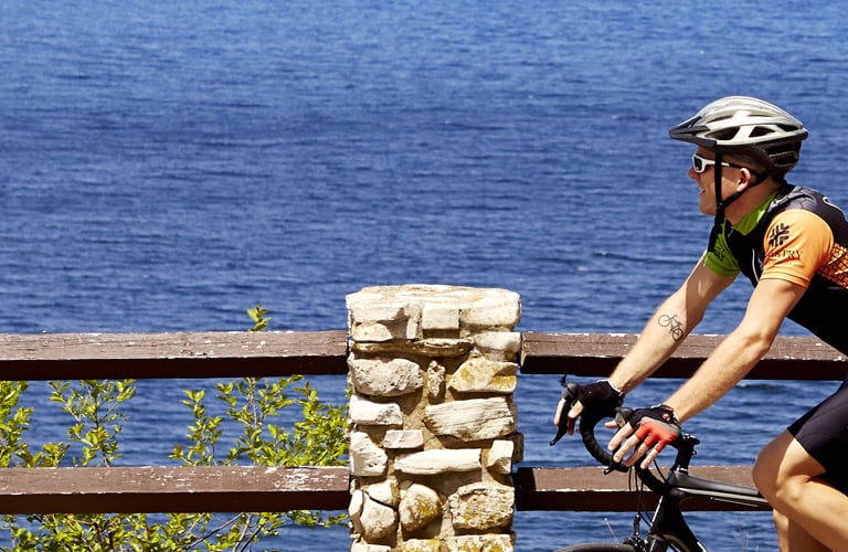 Baileys Harbor A cyclist riding next to the lake.