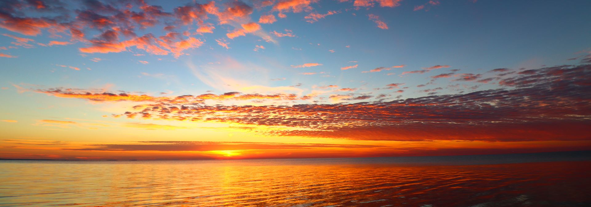 Sunrises & Sunsets in Door County The sun setting over the lake and clouds.