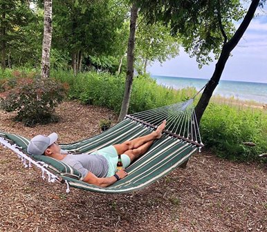 A man taking a nap in a hammock