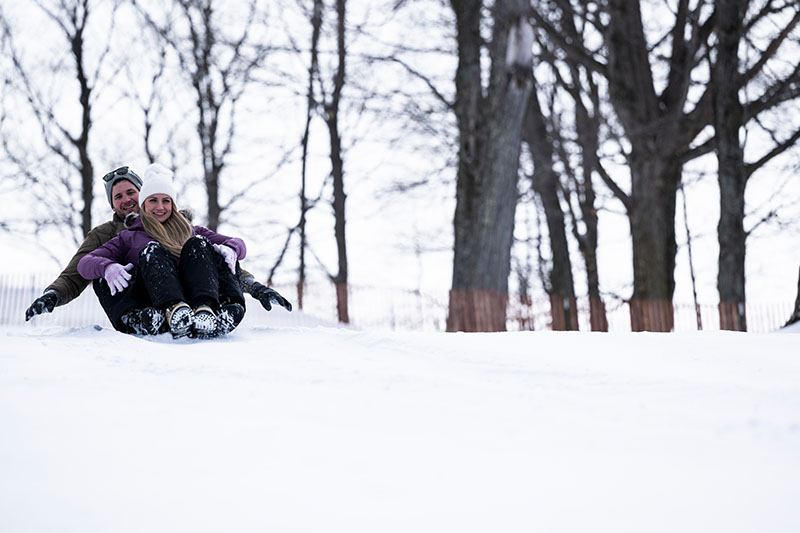 Couple sledding at Hill 17