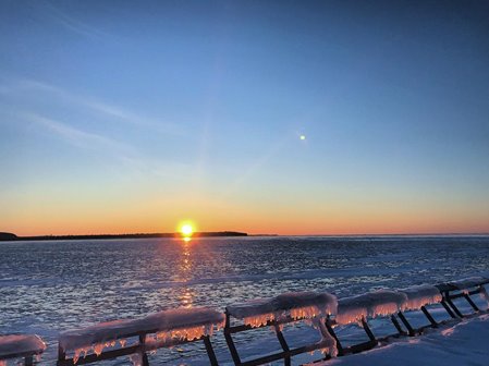 The sun setting over the lake.