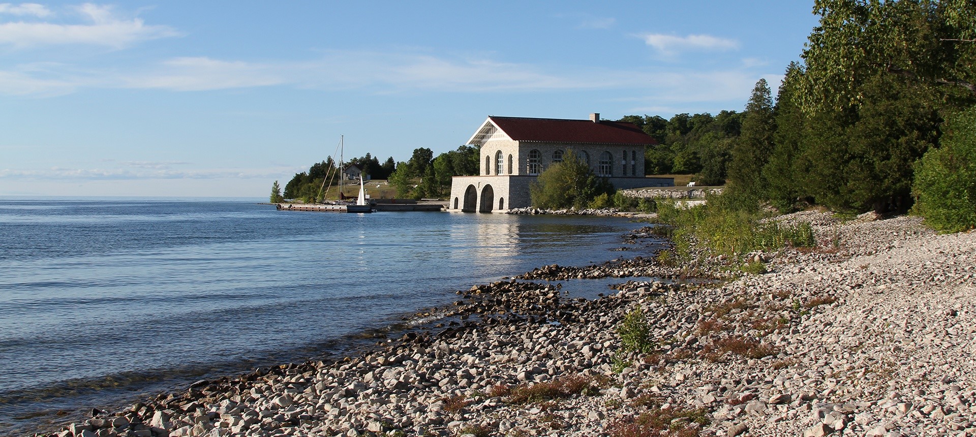 White building in the distance at the lakefront.