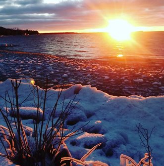 Snowy lakefront at sunrise