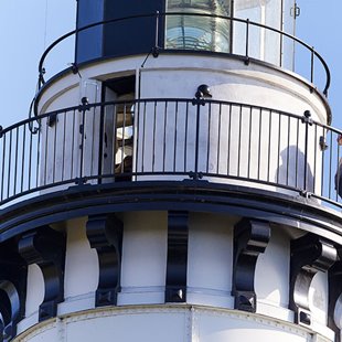 A Closeup of a white lighthouse.