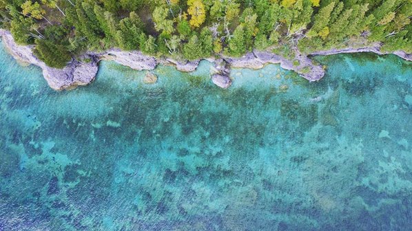 Aerial view of the lake along a cliffline