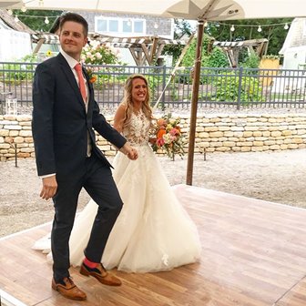 Bride and groom standing on the dance floor.