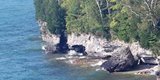 Tree-lined cliffs at the edge of the lake.