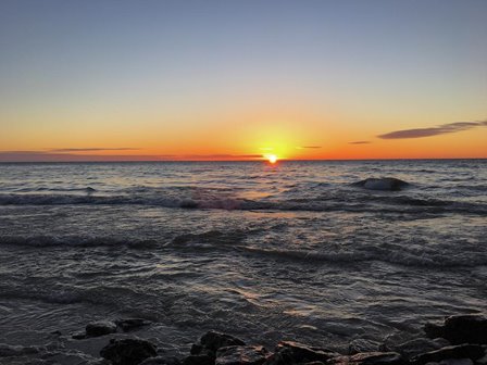 The sun setting over the lake.