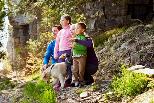 A family with a dog hiking in Peninsula State Park.