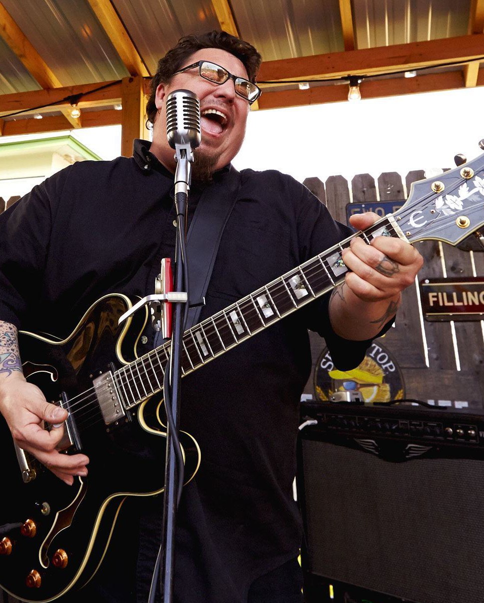 Ephraim A man playing electric guitar and singing